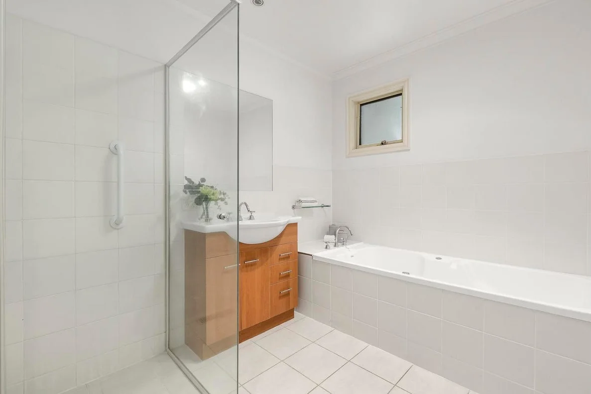 Green Eggs and Ham bathroom before renovation — original beige-tiled state