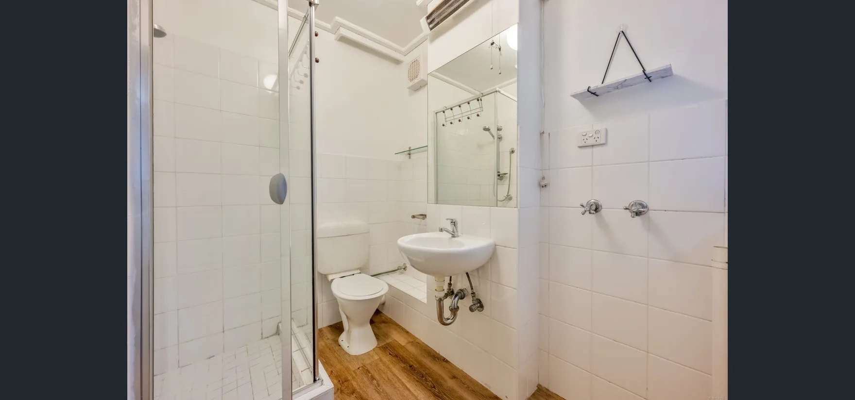 Draft House bathroom before renovation — original white-tiled state